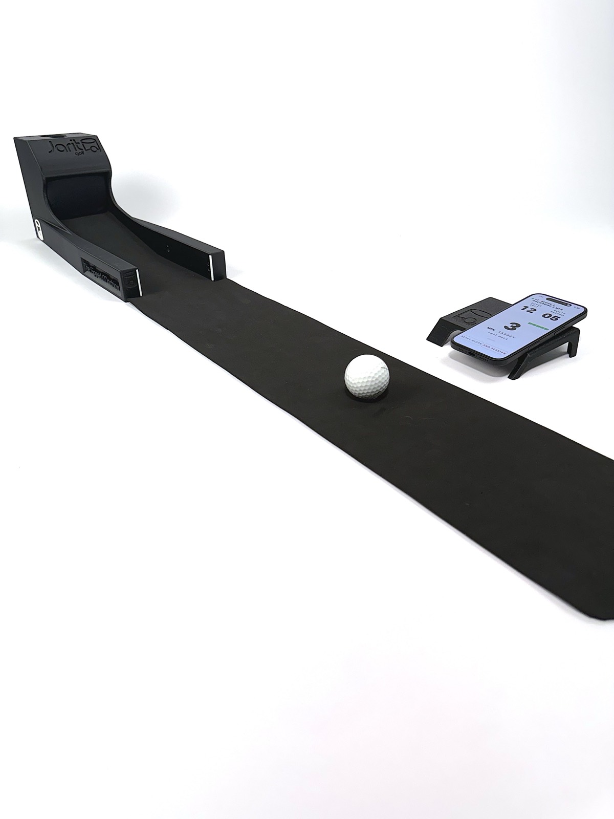 The Speed Machine at a three-quarter angle with a ball on the mat and the phone in its dock showing a Speed Number of 3