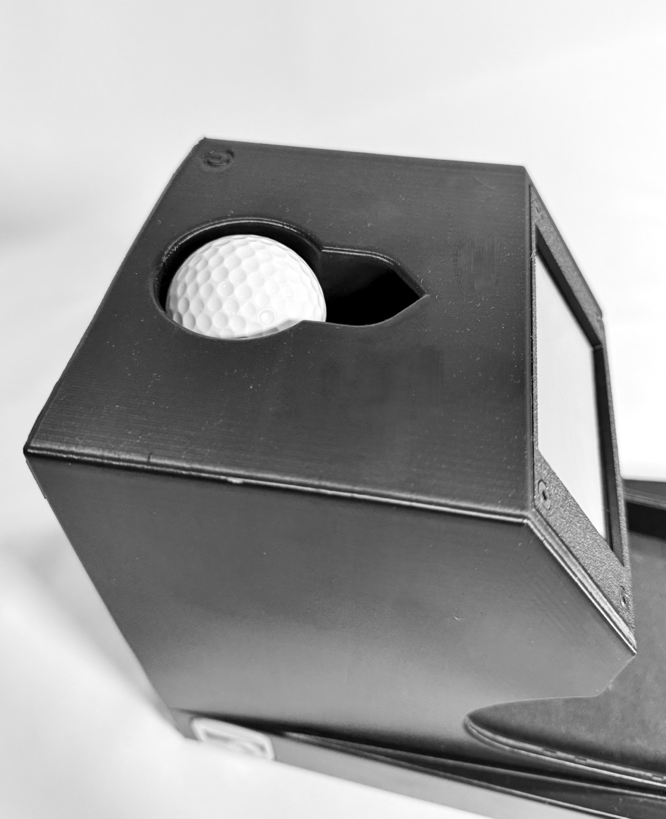Close-up of a golf ball resting in the Speed Machine's ball holder