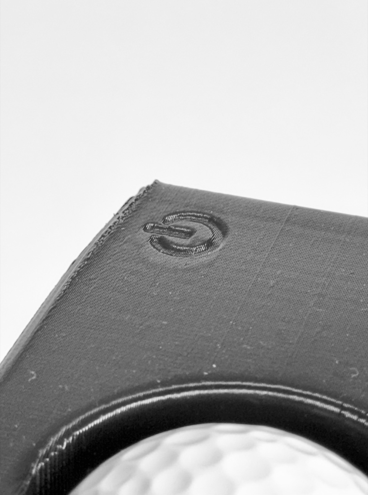 Close-up of an embossed control marking on the Speed Machine's housing