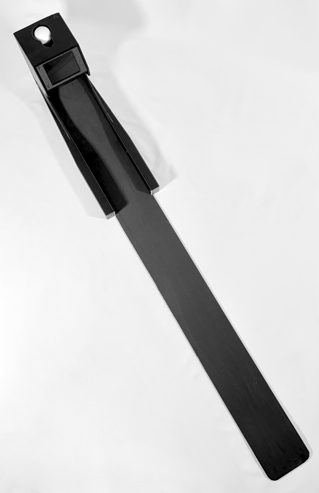 A diagonal top-down view of the Speed Machine's ball return track with a ball loaded at the top