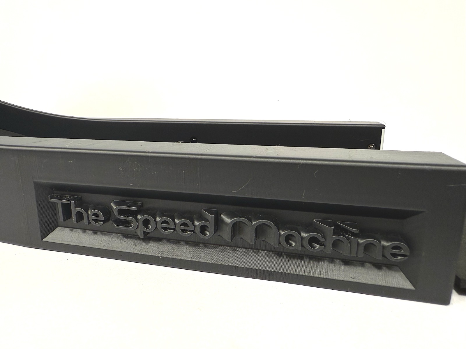 Macro detail of "The Speed Machine" embossed into the side rail of the housing
